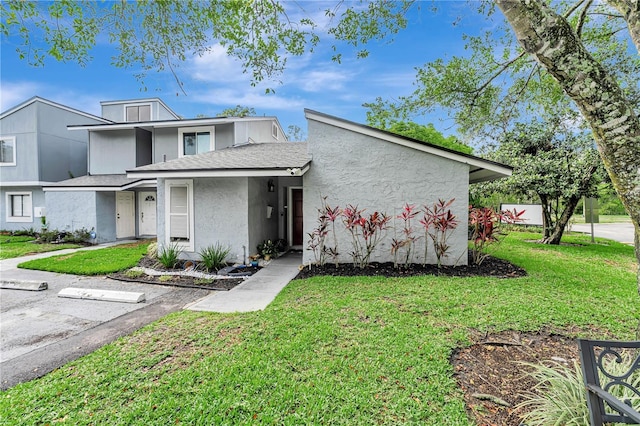 701 Saint Michael Ln, Altamonte Springs, FL 32714 - view of front of property featuring stucco siding, a front yard, and a shingled roof