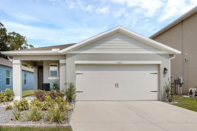 view of front of house with driveway, stucco siding, and an attached garage