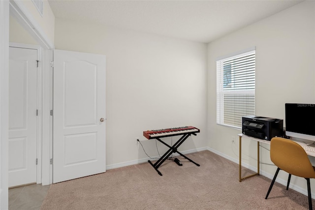 office space featuring light carpet and baseboards