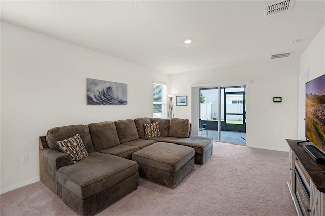 living room with light colored carpet, baseboards, and recessed lighting