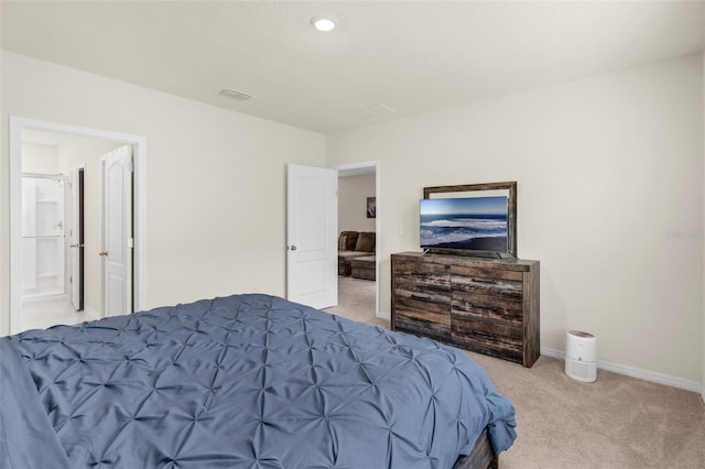 carpeted bedroom with baseboards and ensuite bathroom