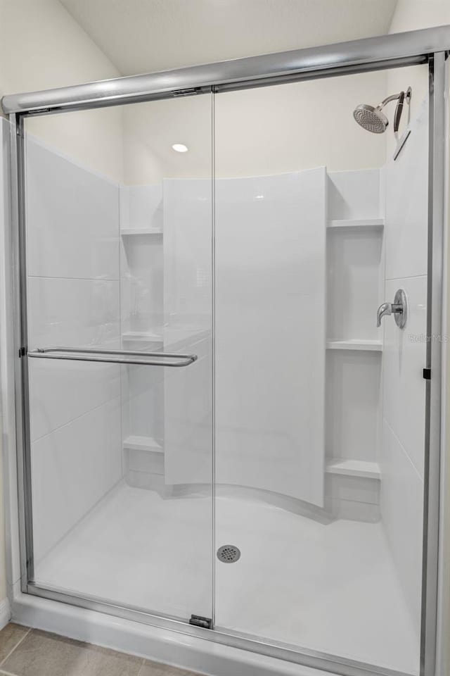 full bath with a shower stall