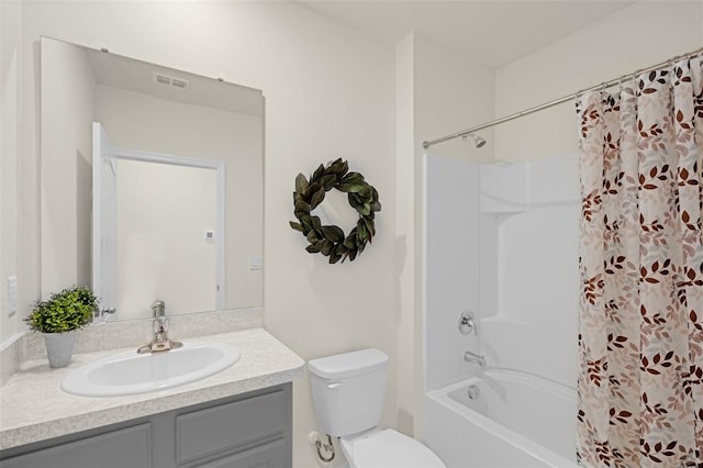 full bath featuring vanity, toilet, and shower / tub combo