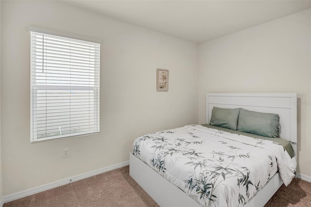 bedroom with carpet and baseboards