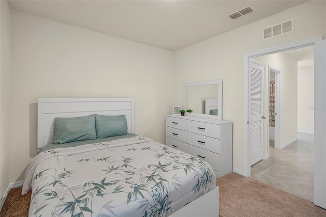 bedroom with light carpet and baseboards