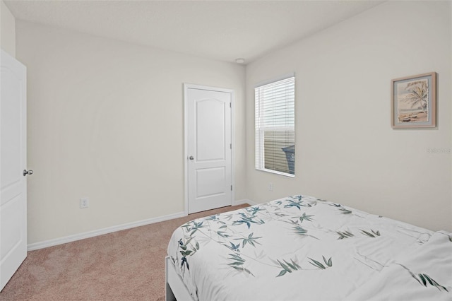 carpeted bedroom featuring baseboards
