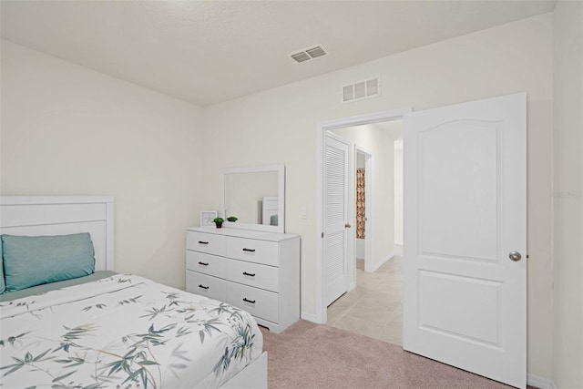 bedroom with light colored carpet and baseboards