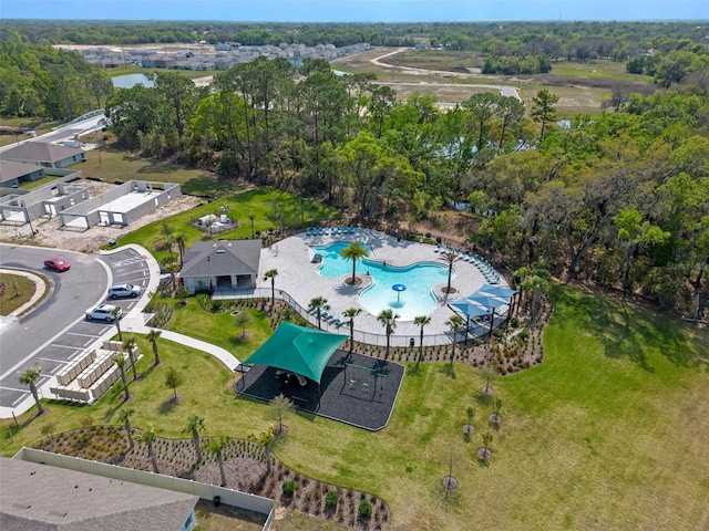 aerial view of property and surrounding area featuring a pool area