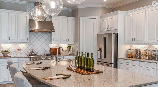 5658 Nevis Ter, Kissimmee, FL 34758 - kitchen featuring high end fridge, a kitchen island with sink, ventilation hood, white cabinetry, and crown molding