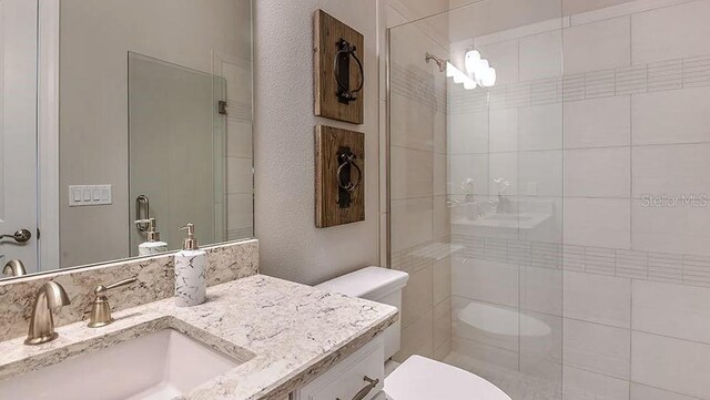 5658 Nevis Ter, Kissimmee, FL 34758 - bathroom featuring toilet, tiled shower, and vanity