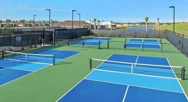 5658 Nevis Ter, Kissimmee, FL 34758 - view of tennis court with fence, community basketball court, and a residential view