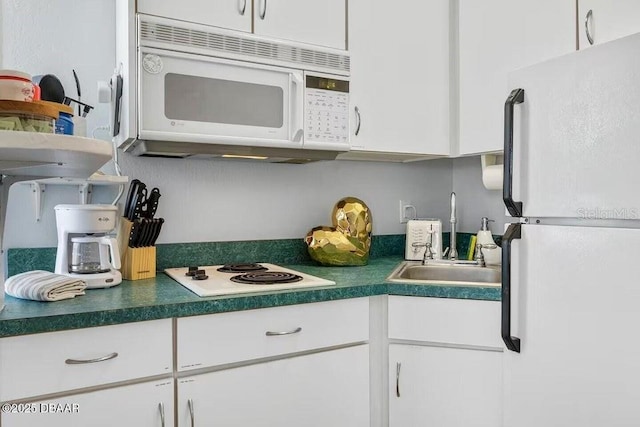 935 S Atlantic Ave Unit 355, Daytona Beach, FL 32118 - kitchen with white appliances, a sink, and white cabinets