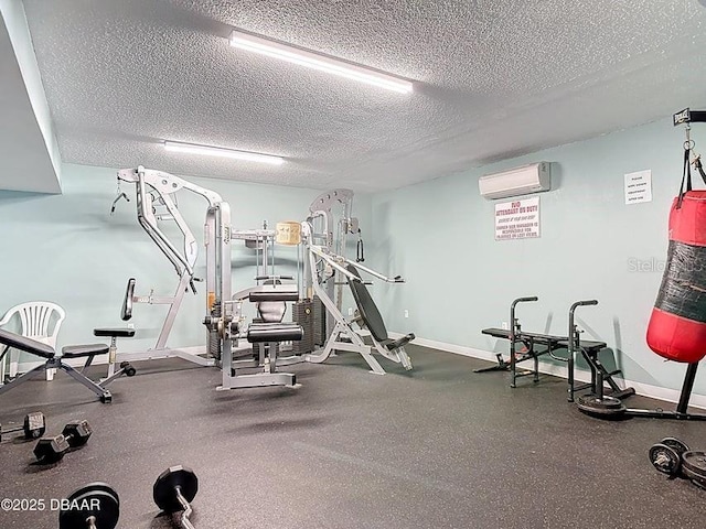 935 S Atlantic Ave Unit 355, Daytona Beach, FL 32118 - workout area with a textured ceiling, an AC wall unit, and baseboards