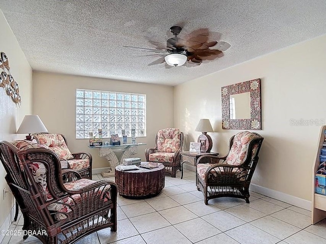 935 S Atlantic Ave Unit 355, Daytona Beach, FL 32118 - sitting room with light tile patterned floors, ceiling fan, baseboards, and a textured ceiling