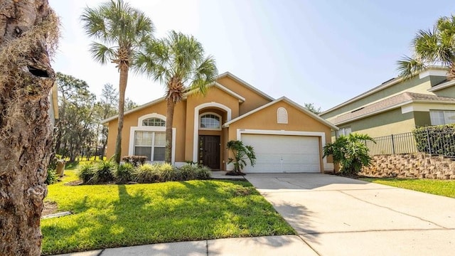 2805 Lido Key Ct, Kissimmee, FL 34747 - mediterranean / spanish-style house with an attached garage, stucco siding, and driveway