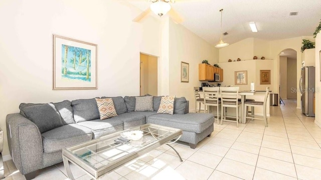 2805 Lido Key Ct, Kissimmee, FL 34747 - living area with arched walkways, light tile patterned flooring, ceiling fan, and high vaulted ceiling