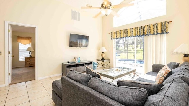 2805 Lido Key Ct, Kissimmee, FL 34747 - tiled living area featuring a ceiling fan, baseboards, and a towering ceiling