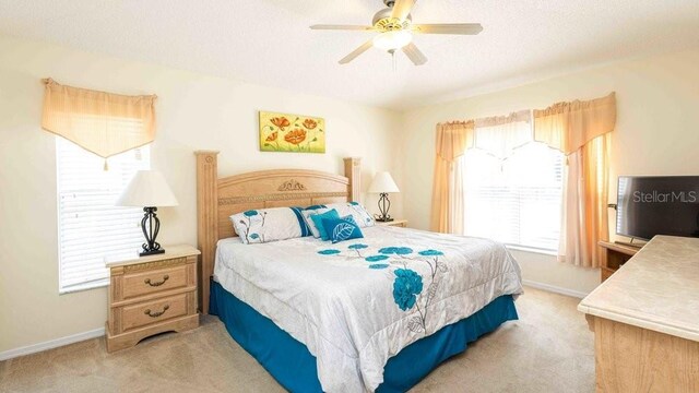 2805 Lido Key Ct, Kissimmee, FL 34747 - bedroom with light colored carpet, baseboards, and a ceiling fan