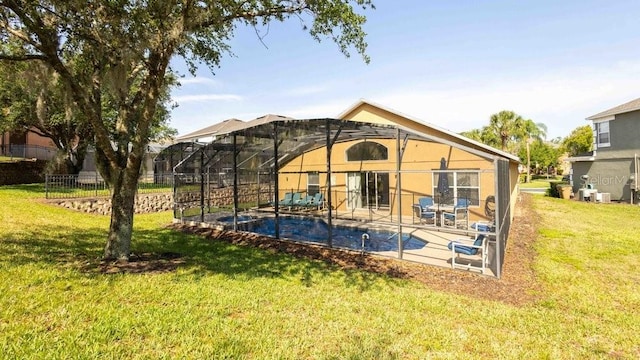 2805 Lido Key Ct, Kissimmee, FL 34747 - back of property with a lawn, stucco siding, a patio, and a lanai