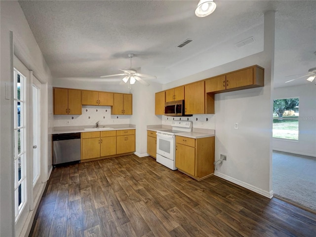 3090 Yorkshire Dr, Deltona, FL 32738 - kitchen with appliances with stainless steel finishes, ceiling fan, dark wood-type flooring, vaulted ceiling, and baseboards