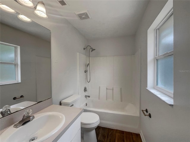 3090 Yorkshire Dr, Deltona, FL 32738 - bathroom with toilet, wood finished floors, vanity, and washtub / shower combination