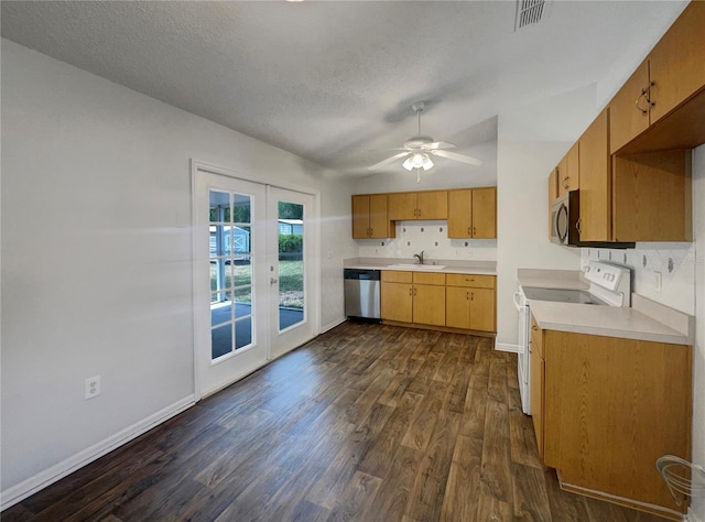 3090 Yorkshire Dr, Deltona, FL 32738 - kitchen with stainless steel appliances, french doors, a sink, dark wood-style flooring, and light countertops