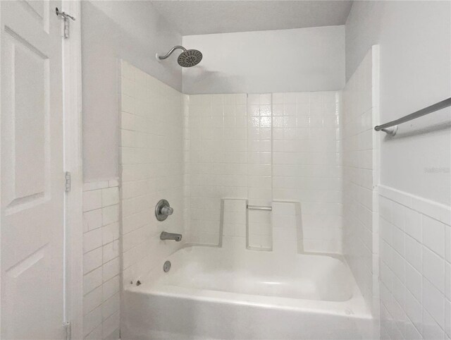 3090 Yorkshire Dr, Deltona, FL 32738 - full bathroom featuring tile walls and shower / washtub combination