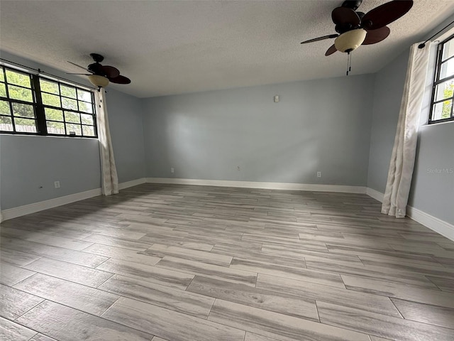 6615 Beamer Way, Orlando, FL 32807 - unfurnished room featuring ceiling fan, a textured ceiling, light wood-type flooring, and baseboards