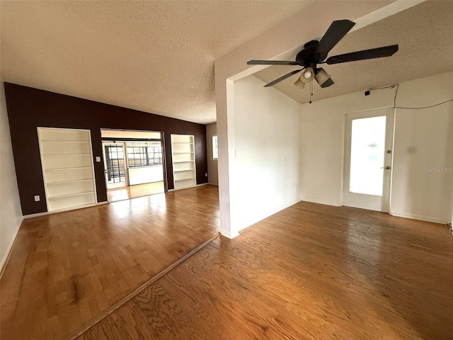 6615 Beamer Way, Orlando, FL 32807 - empty room featuring lofted ceiling, ceiling fan, a textured ceiling, wood finished floors, and baseboards