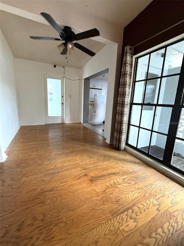 6615 Beamer Way, Orlando, FL 32807 - empty room featuring a ceiling fan, light wood-style floors, baseboards, and a textured ceiling