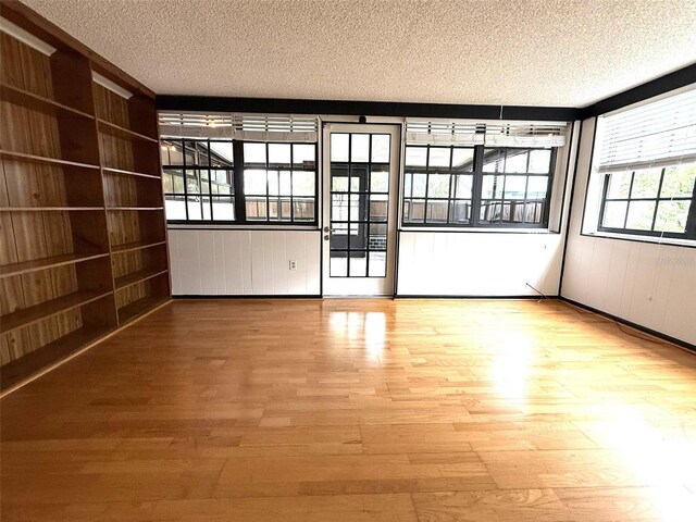 6615 Beamer Way, Orlando, FL 32807 - unfurnished room with a textured ceiling and wood finished floors