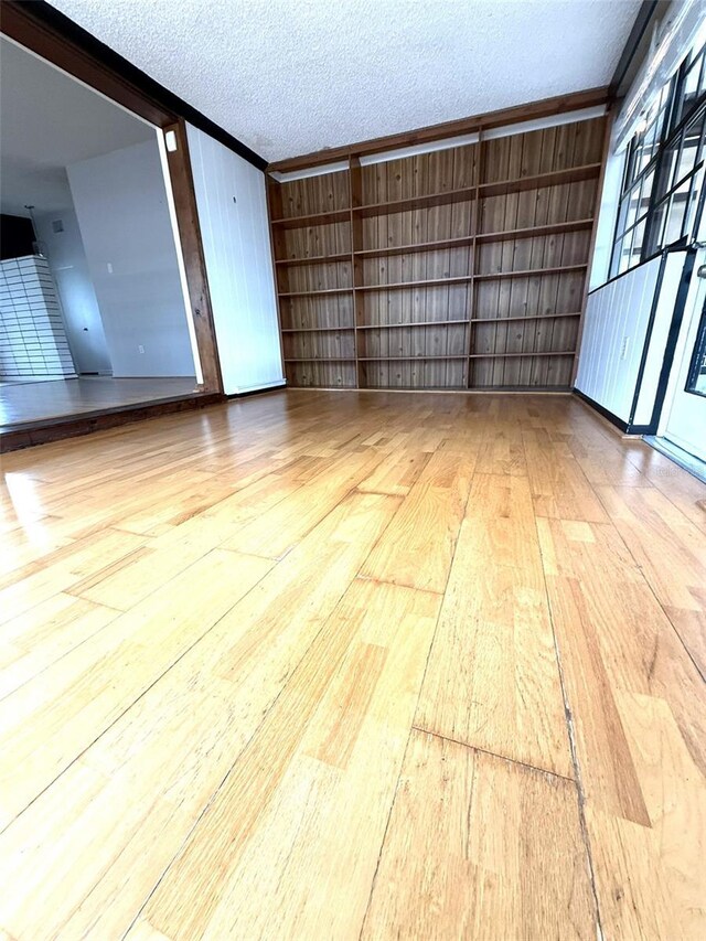 6615 Beamer Way, Orlando, FL 32807 - empty room featuring a textured ceiling, wood finished floors, ornamental molding, and built in features