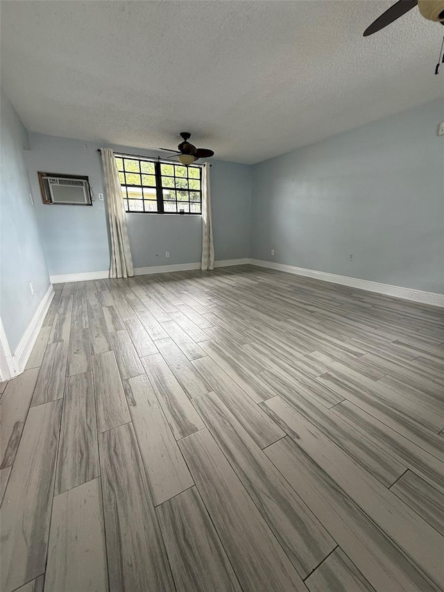 6615 Beamer Way, Orlando, FL 32807 - empty room featuring a ceiling fan, wood finished floors, a textured ceiling, and baseboards