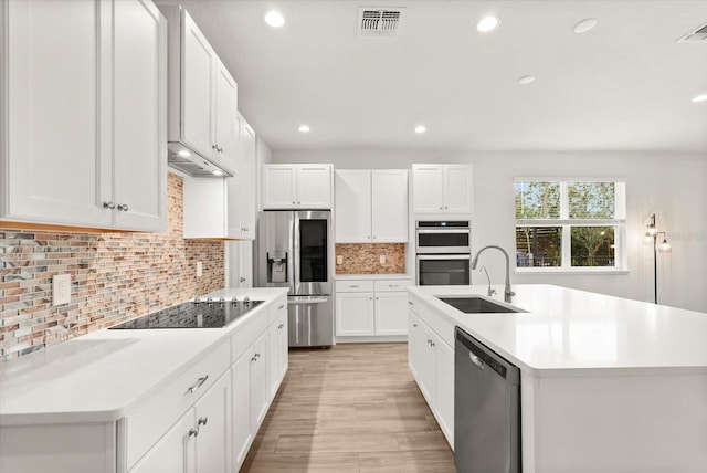 3635 Arbordale Loop, Sanford, FL 32771 - kitchen with stainless steel appliances, a sink, recessed lighting, light countertops, and decorative backsplash