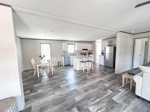 3790 NW 4th Ave, Okeechobee, FL 34972 - kitchen featuring freestanding refrigerator, dishwasher, open floor plan, white cabinetry, and light countertops