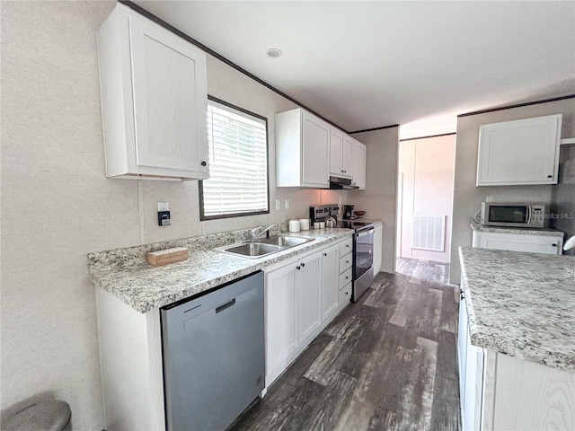 3790 NW 4th Ave, Okeechobee, FL 34972 - kitchen with appliances with stainless steel finishes, a sink, dark wood finished floors, and white cabinets