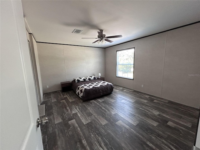 3790 NW 4th Ave, Okeechobee, FL 34972 - bedroom with wood finished floors, ceiling fan, and a decorative wall