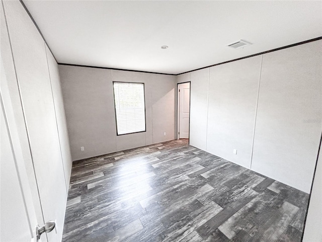 3790 NW 4th Ave, Okeechobee, FL 34972 - unfurnished bedroom featuring wood finished floors and crown molding