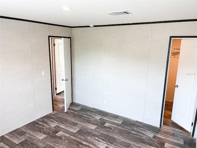 3790 NW 4th Ave, Okeechobee, FL 34972 - unfurnished room featuring a decorative wall, dark wood finished floors, and ornamental molding