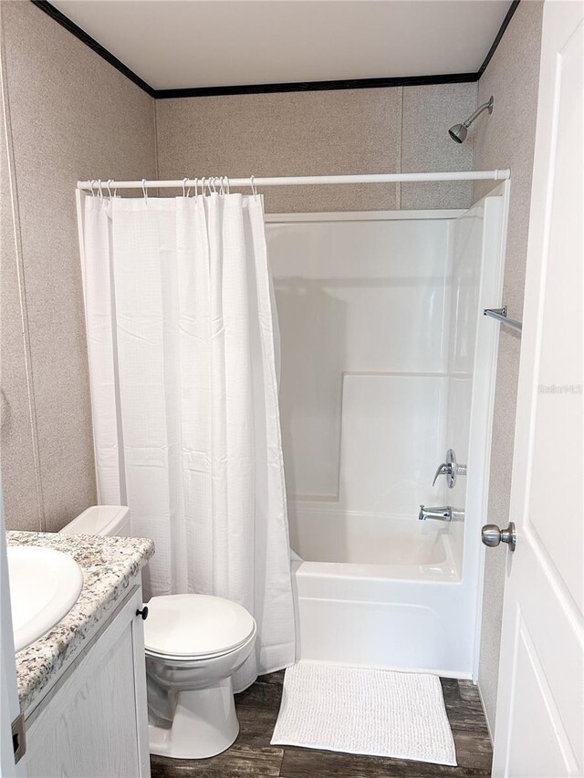 3790 NW 4th Ave, Okeechobee, FL 34972 - bathroom with wood finished floors, shower / bath combo with shower curtain, toilet, vanity, and crown molding