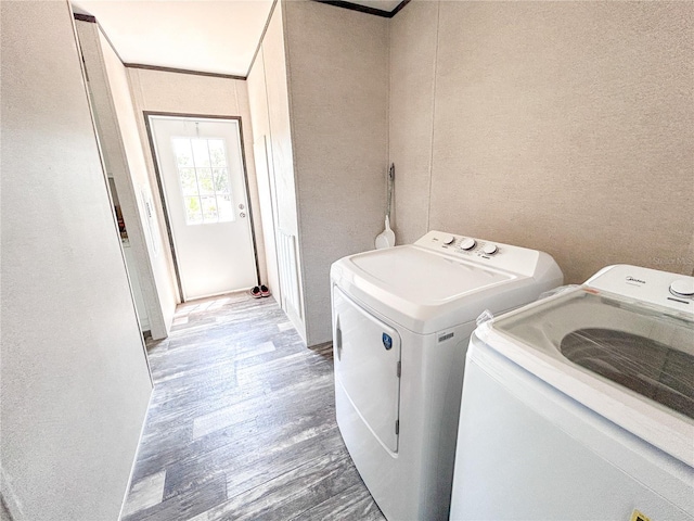 3790 NW 4th Ave, Okeechobee, FL 34972 - washroom with washing machine and clothes dryer, wood finished floors, and a textured wall