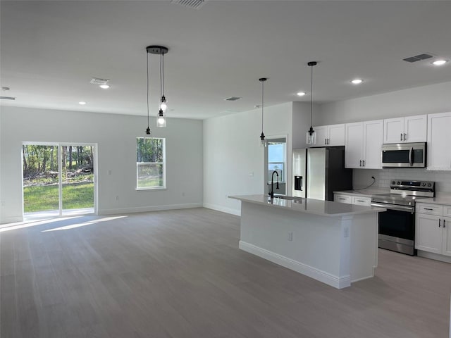 5153 SW 159th St, Ocala, FL 34473 - kitchen with stainless steel appliances, light wood-style floors, recessed lighting, and decorative backsplash