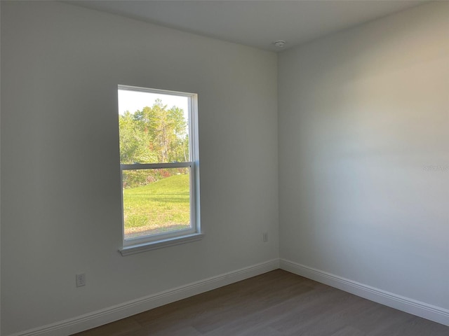 5153 SW 159th St, Ocala, FL 34473 - empty room with healthy amount of natural light, baseboards, and wood finished floors