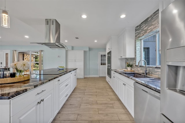 277 Sunrise Pt, Lake Mary, FL 32746 - kitchen featuring stainless steel appliances, a sink, island range hood, dark stone counters, and recessed lighting