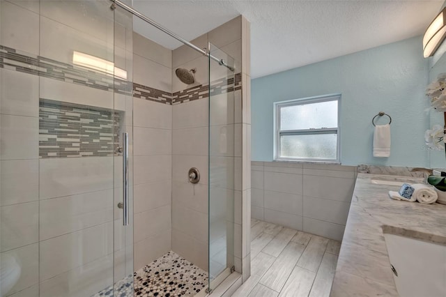 277 Sunrise Pt, Lake Mary, FL 32746 - full bathroom featuring tile walls, a stall shower, double vanity, and a wainscoted wall