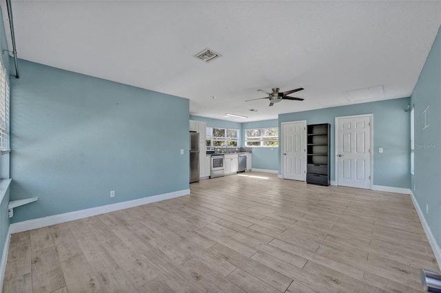 277 Sunrise Pt, Lake Mary, FL 32746 - unfurnished living room featuring a ceiling fan, baseboards, and light wood-style floors