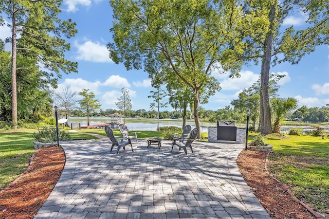 277 Sunrise Pt, Lake Mary, FL 32746 - view of home's community featuring an outdoor fire pit, a patio area, a lawn, and a water view