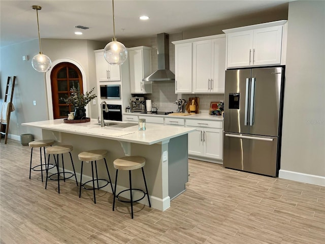 1266 Spotted Sandpiper Loop, Winter Springs, FL 32708 - kitchen with black appliances, wall chimney exhaust hood, baseboards, decorative backsplash, and a kitchen breakfast bar