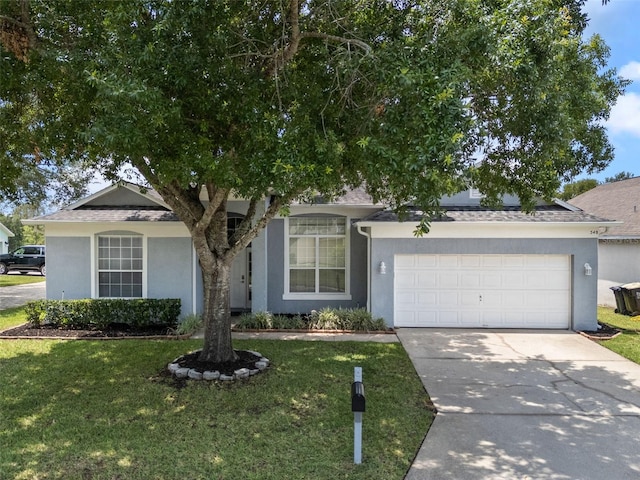 obstructed view of property featuring stucco siding, driveway, and a front lawn