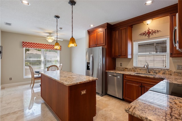 5973 Chesapeake Park Unit 58, Orlando, FL 32819 - kitchen featuring stainless steel appliances, a ceiling fan, a kitchen island, recessed lighting, and decorative light fixtures